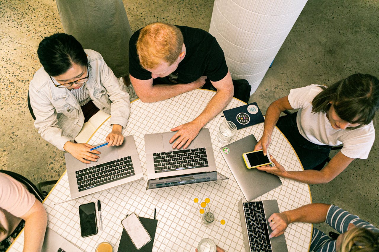 services-02 Top view of diverse team collaboratively working in a modern office setting.